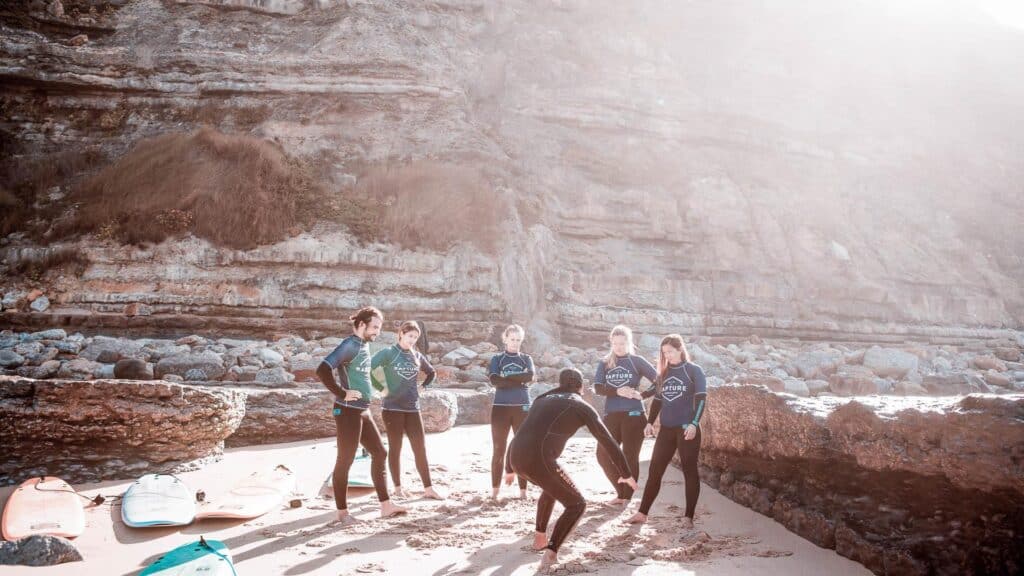 An image of an instructor teaching surfers at Rapture Surfcamps