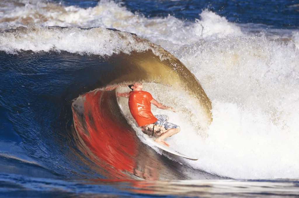 Surfer getting tubed at a weird wave in Zambia